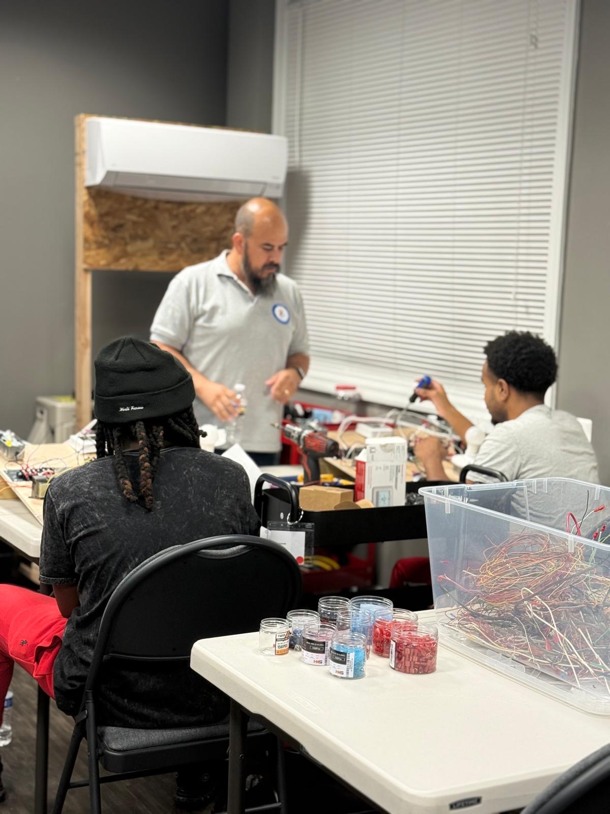 TB-HVAC instructor working with students